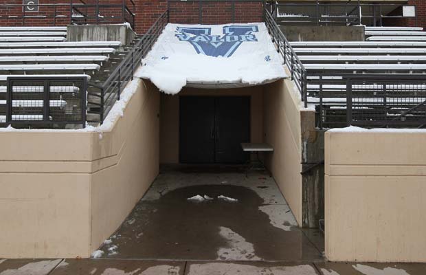 Snow hangs from a Valor Christian banner that covers the tunnel leading to the locker rooms.