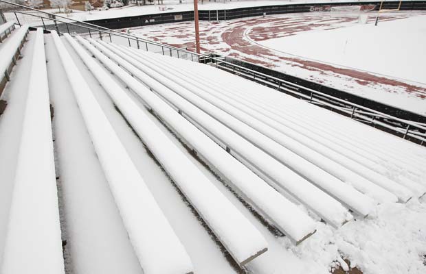 The stands on the home side of the field are covered in snow at All City Stadium.