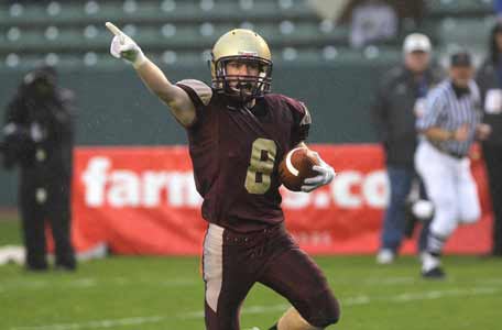 The Bishop School's Robby Stiefler celebrates while returning an interception for a touchdown.