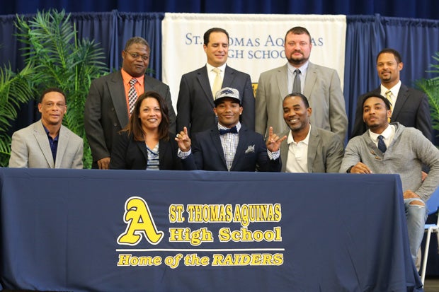 Jaxson Kincaide of St. Thomas Aquinas (Fort Lauderdale, Fla.) celebrates signing with Nevada.