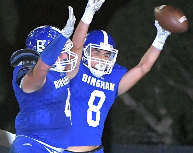 Bingham celebrates its 50-yard halfback option touchdown scored by Jake Cragun (8).
