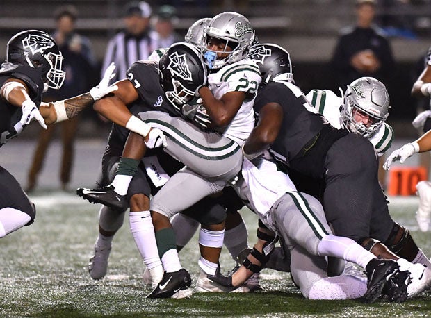 De La Salls running back James Coby is sandwiched by two Bosco defenders.  
