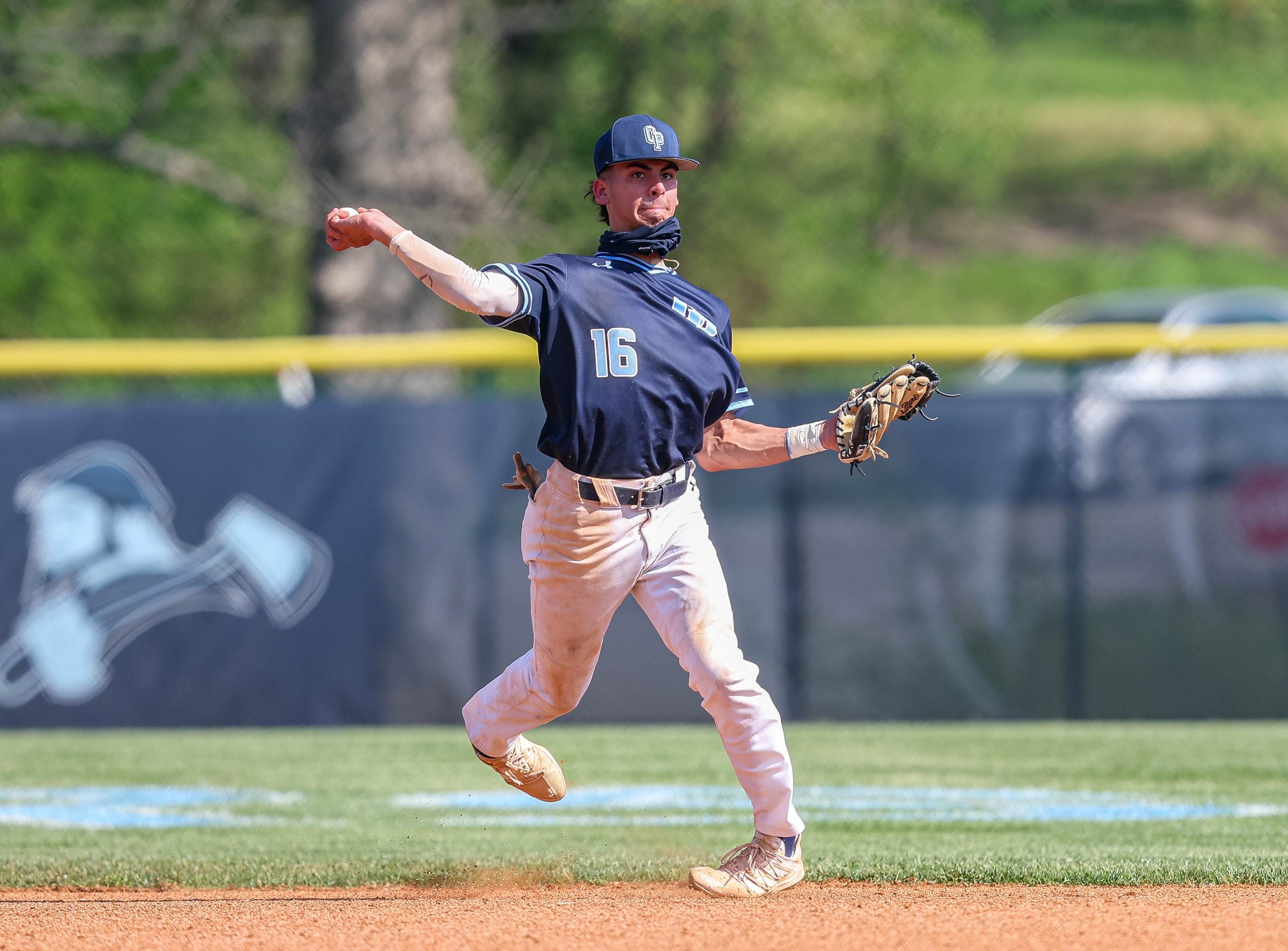 Oak Park's Anthony Valadez makes a throw to first during a game with Lee's Summit. 
