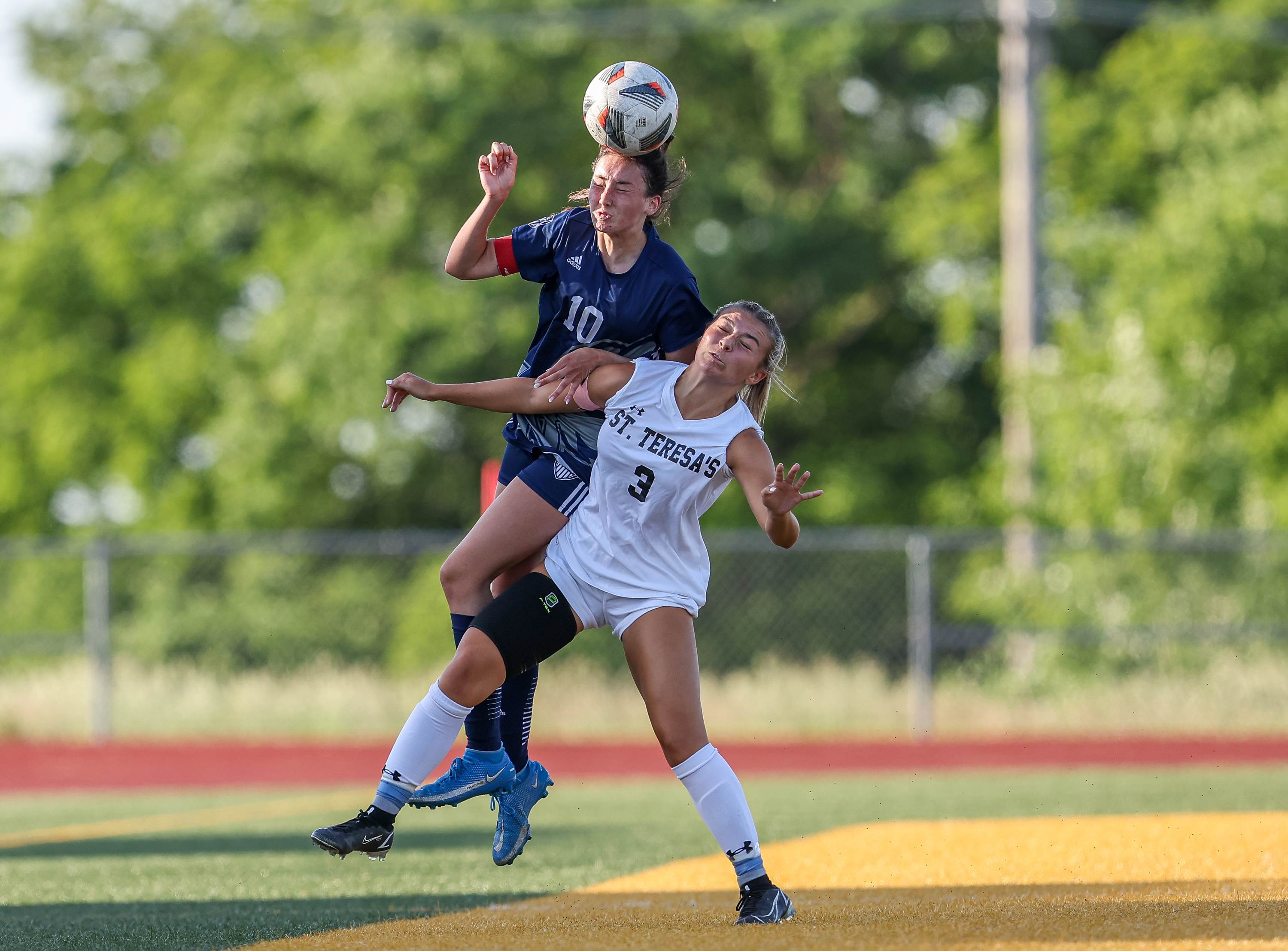 Liberty North's Ava Baker wins the battle for a header over Sophie Harlan of St. Teresa's Academy during a MSHSAA Class 4 Quarterfinal game. Liberty North won 2-0.