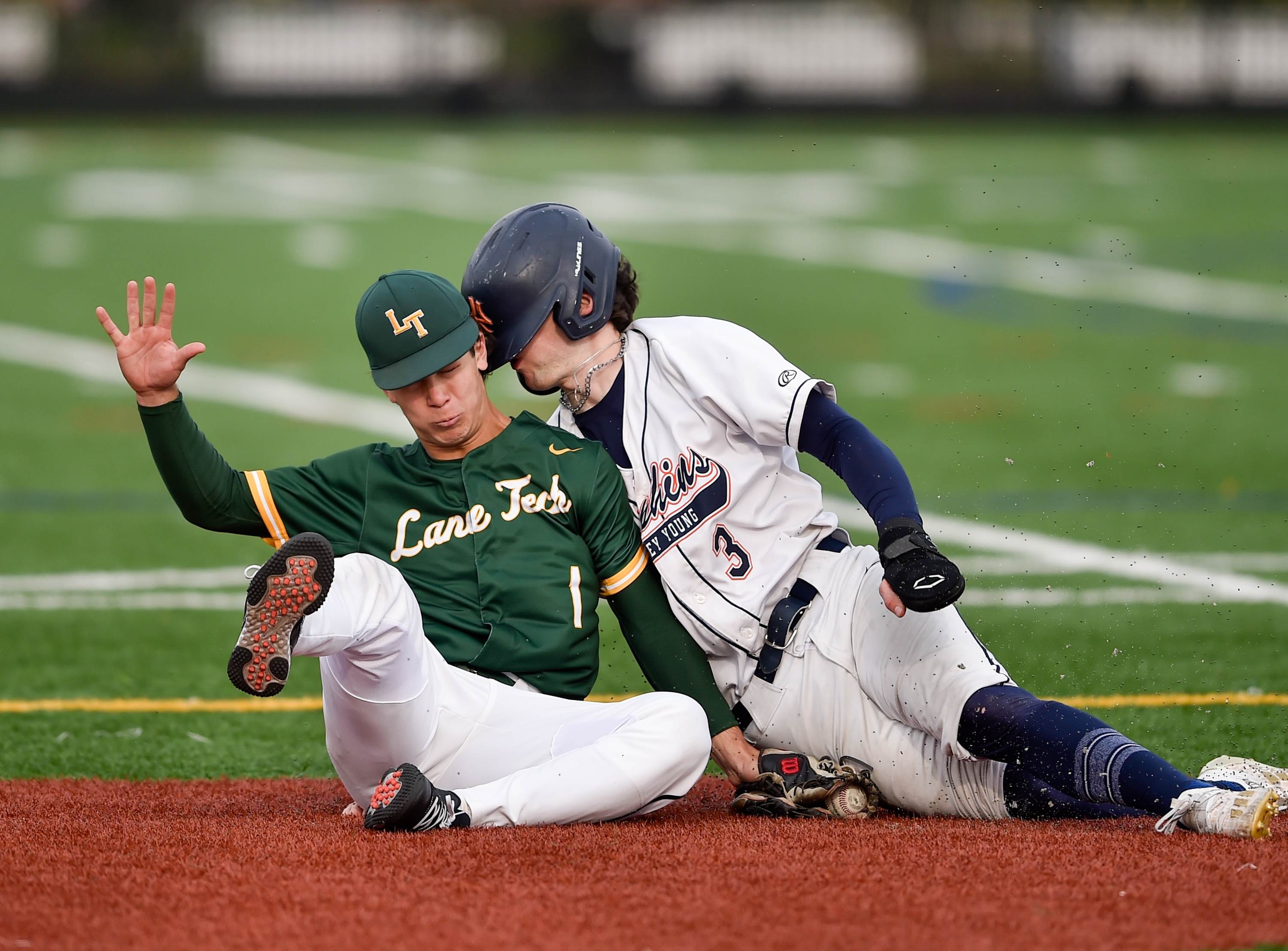 Lane Tech's Nick Lagges tags out Whitney Young's Brendan Summerhill as he tries to slide into second base during a May 2 game at Whitney Young's Michelle Obama Field in Chicago.