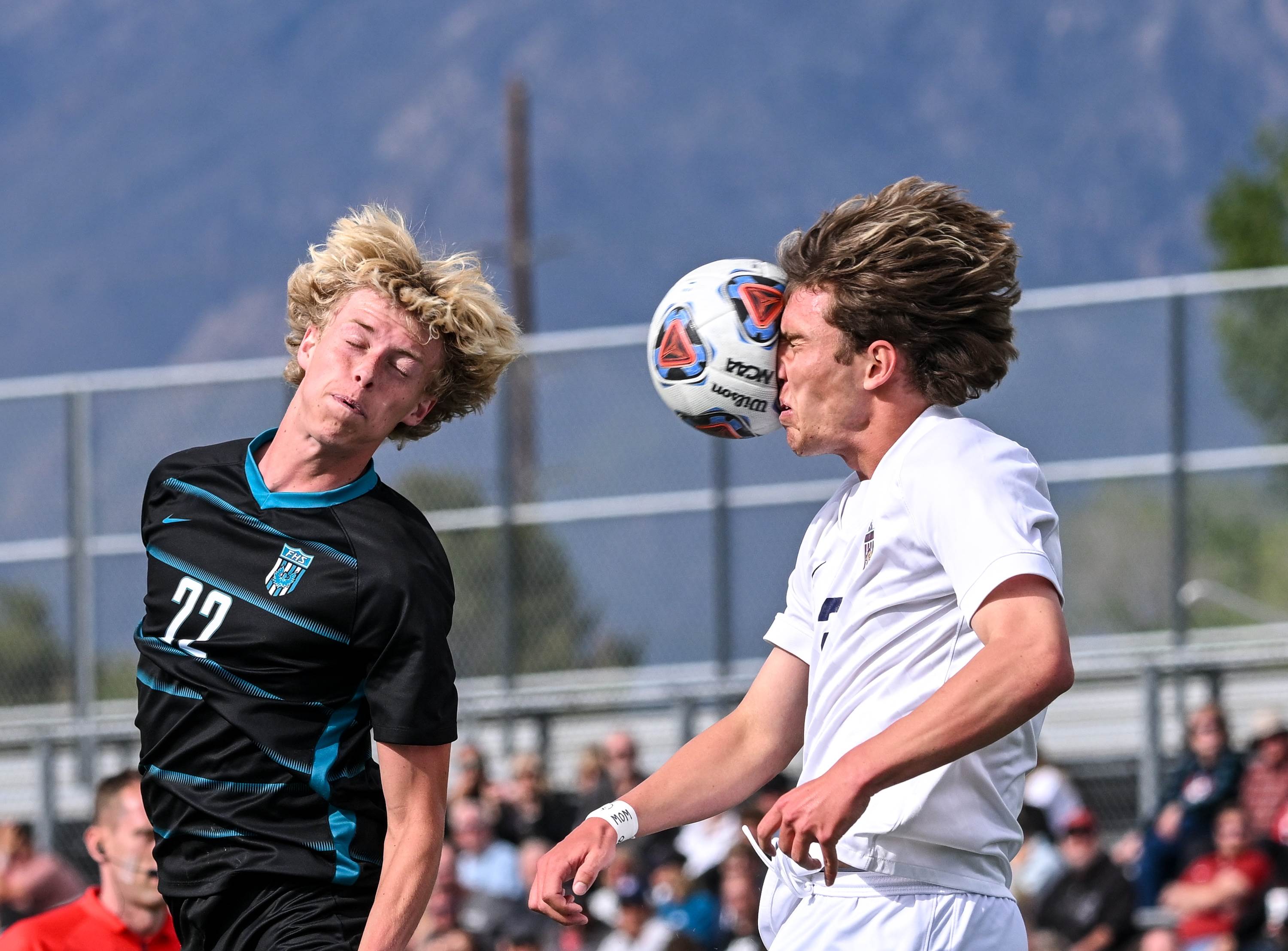 Farmington's Abe Ashby heads the ball into the face of Herriman's Jase Bailey during their Utah 6A semifinal match.