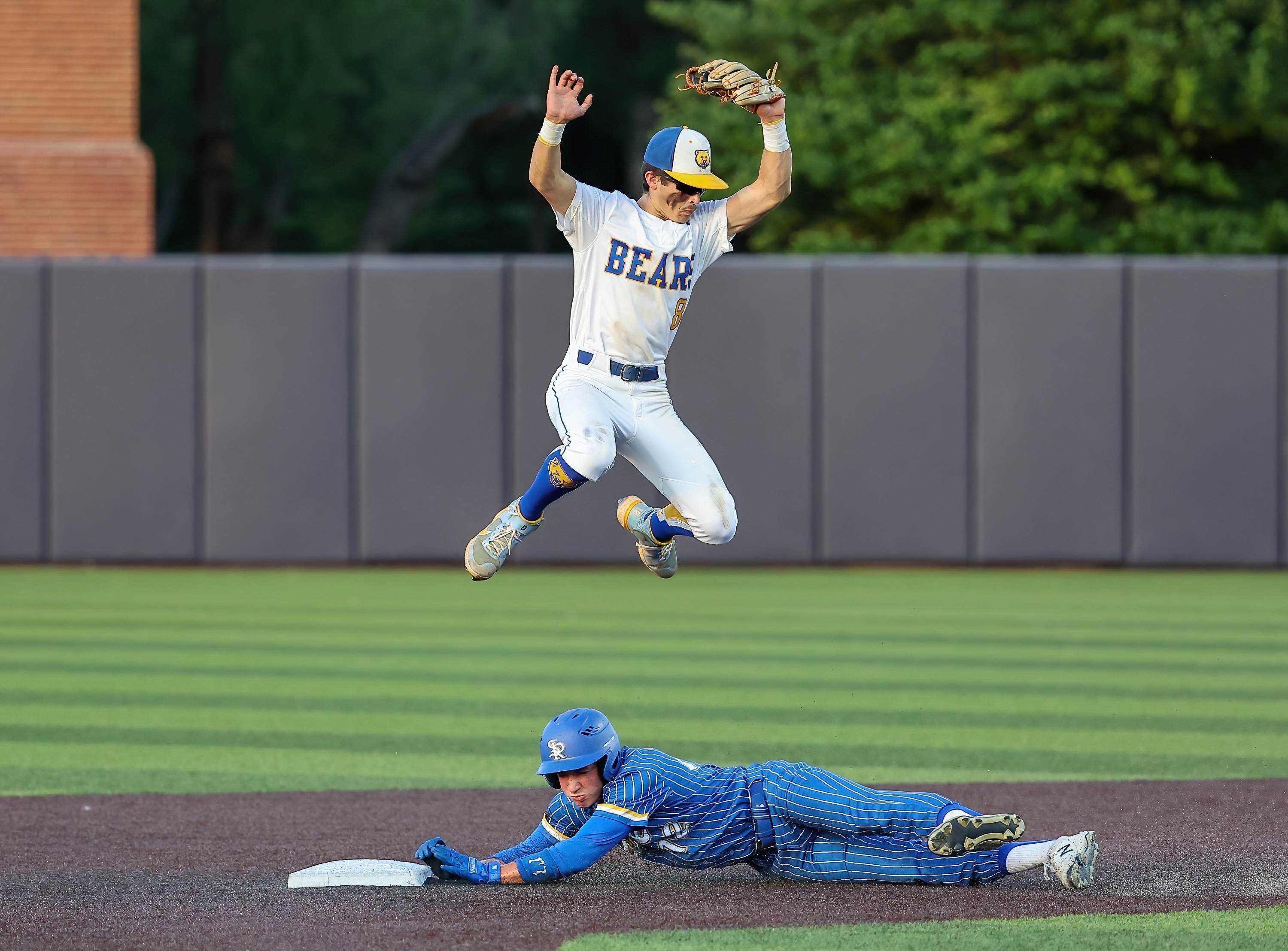 Sunnyvale’s Landry Laird slides in safely at second base while Brownsboro’s Landon Hatton leaps to catch the ball during a UIL 4A Bi-District playoff game.