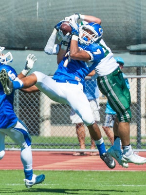 Kavapele Maka (7) goes up for a leaping
interception.