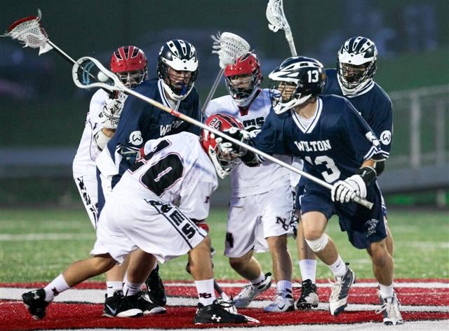 New Canaan (white jerseys) and Wilton battle it out May 1.