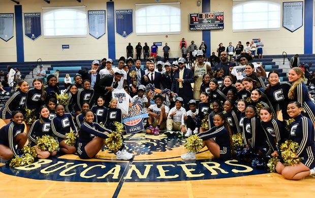 The Calvary Christian Academy players, staff and cheerleaders pose following the team's State Champions Invitational title Saturday in Tampa.