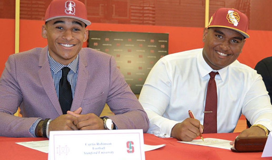 Mater Dei (Santa Ana, Calif.) players Curtis Robinson (Stanford) and Frank Martin II (USC) looking as sharp as the pointy pens they are about to sign with.