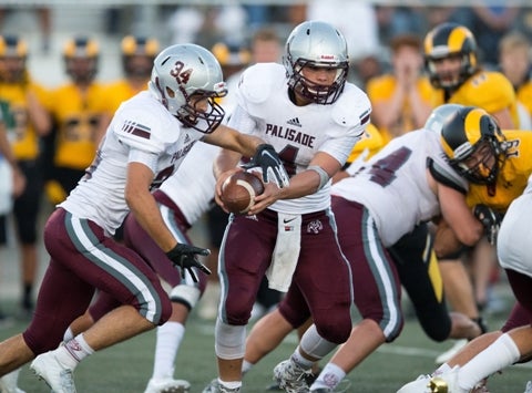 Quarterback Cam Tucker (4) leads a potent Palisade rushing attack against Class 3A defending state champion Palmer Ridge.