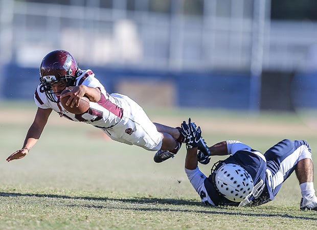 A Sherman Oaks CES (Calif.) player is tripped up by a Fulton defender.
