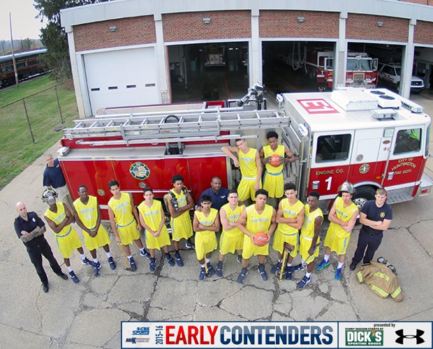 Players and coaches pose with personnel from the City of Huntington Fire Department.