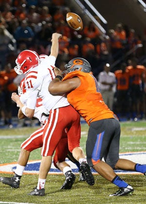 Haskell Garrett smashes his way to thequarterback Friday.