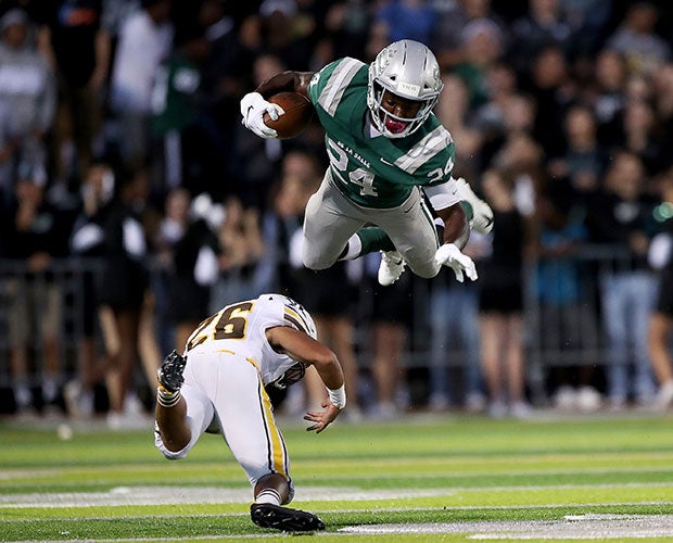 De La Salle (Calif.) running back Shamar Garrett is tripped up by St. Francis defender Logan Espiritu.