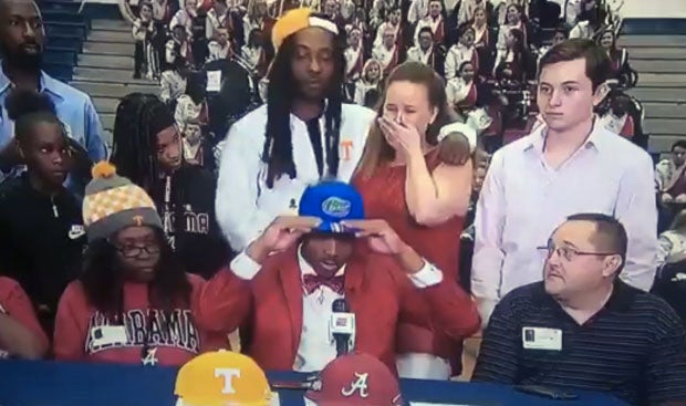 Jacob Copeland (center) tries on Florida cap, signaling his choice to the Gators, which didn't sit well with his mom (to his right). 
