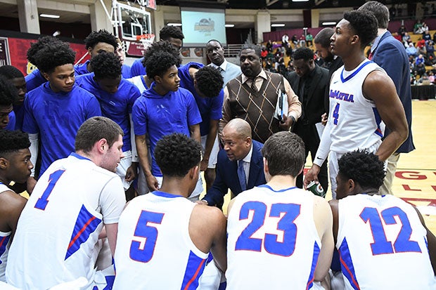 Even without current Michigan freshman star Hunter Dickinson, DeMatha continues to win big under head coach Mike Jones (center, kneeling).