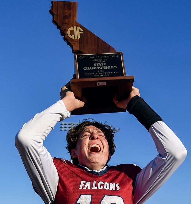 Jax Leatherwood holds up championship hardware.