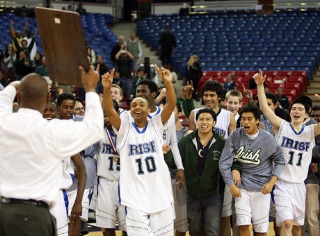 Sacred Heart Cathedral coach Darrell Barbour holds up the CIF Northern California Division III plaque last year after a victory over Bishop O'Dowd. DeOndre Otis (10) wants to hold the hardware first.