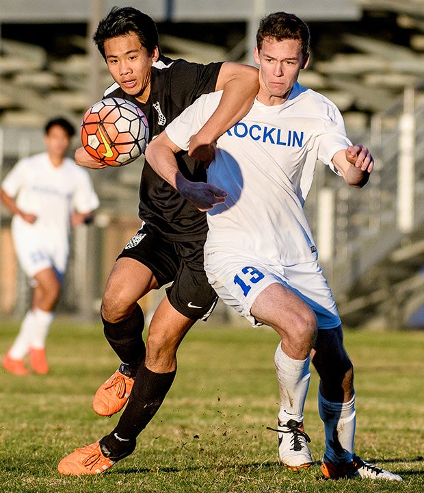 Rocklin's (Calif.) Cole Henderson (right) battles a Granite Bay player for control of the ball.