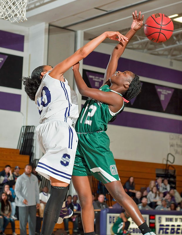 Denver South (Colo.) forward Brittany Roberts (left) blocks a shot by George Washington's Darionna Ray.