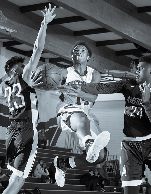 A Kennedy (Fremont, Calif.) player splits two American (Fremont, Calif.) defenders during a junior varsity game.