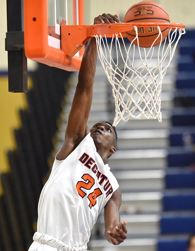 Decatur (Wash.) guard Floyd Wedderburn finishes off a one-handed dunk along the baseline against Enumclaw.