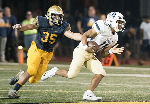 Bosco quarterback Re-Al Mitchell is chased by an Aquinas defender.