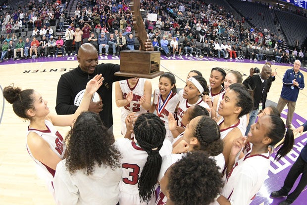 West Campus coach John Langston holds up his school's first state title. 