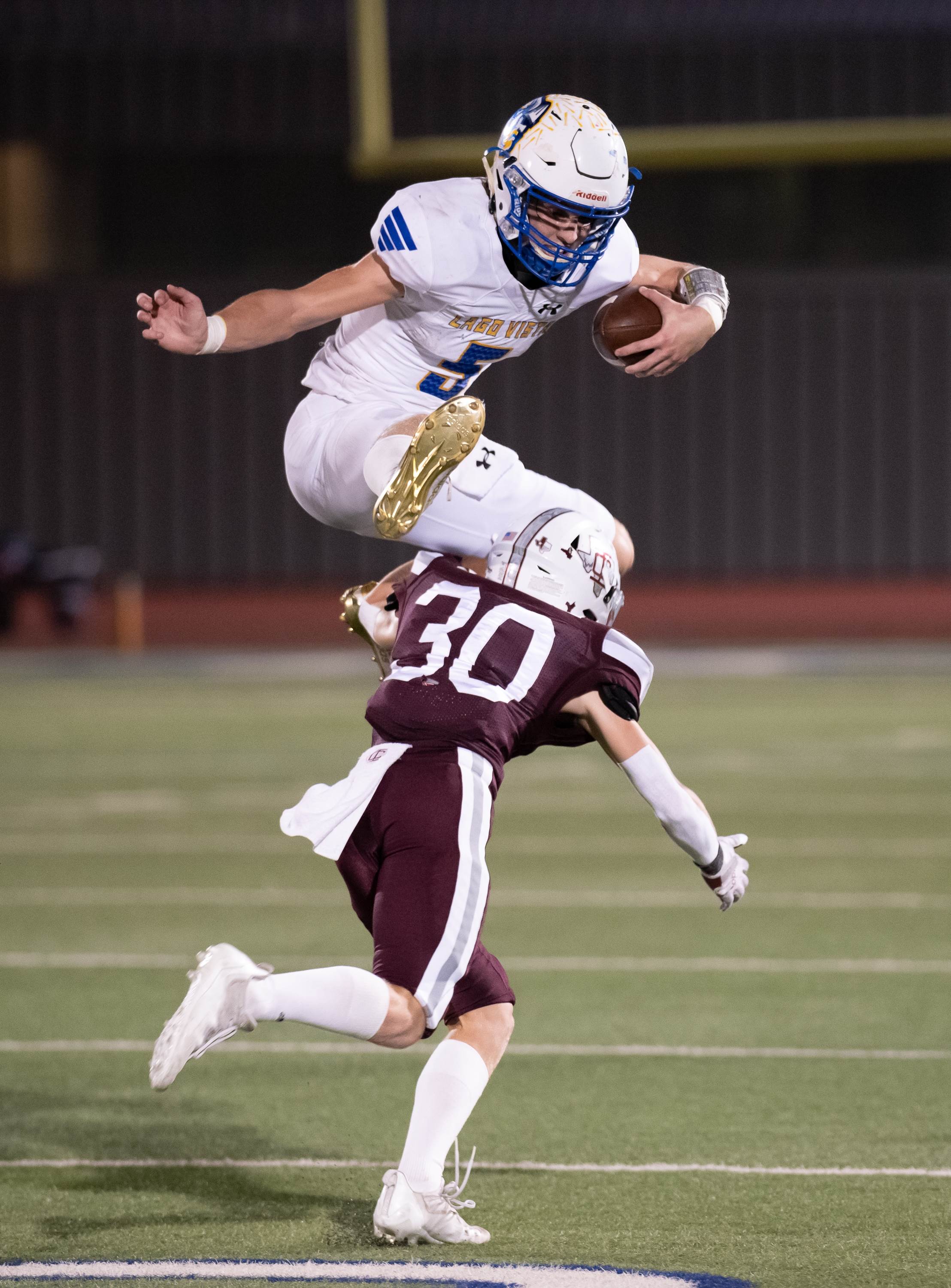 Lago Vista quarterback Bowen Stobb leaps a defender during a long gain in the Vikings' 35-21 victory over Industrial in the UIL 3A Division 1 quarterfinal game.