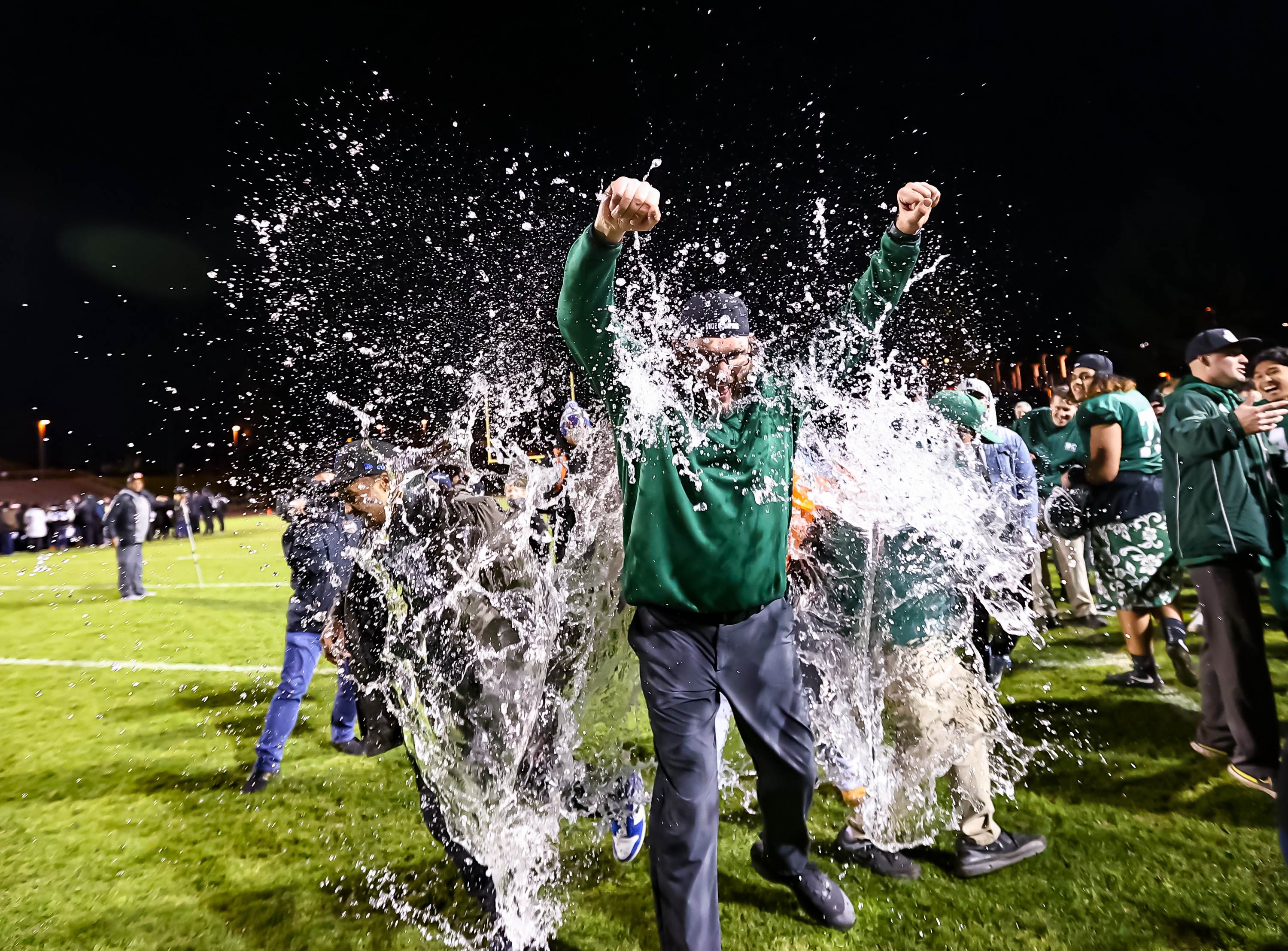 Sacred Heart Cathedral head coach Barry McLaughlin is doused with water after the Fighting Irish's 48-29 win over Northview in the CIF Division 4-A state finals.