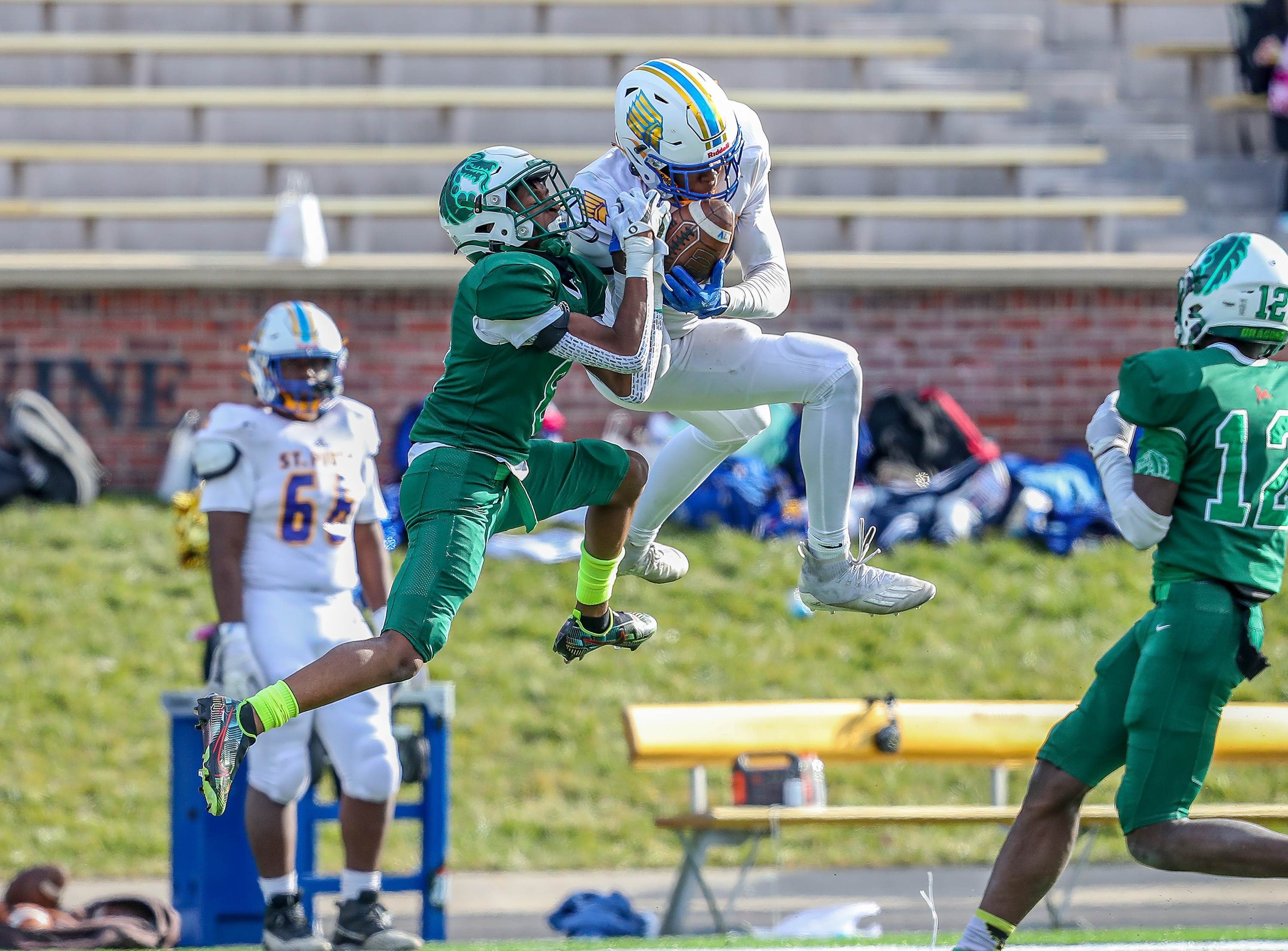 St. Pius receiver Jayshawn Ross hauls in a tough catch in front of St. Mary's defender Farand Washington during Missouri's Class 4 MSHSAA Show-Me Bowl game.