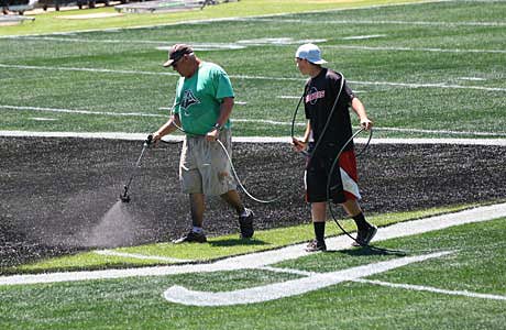 Workers get one of the main fields ready Sunday for Monday's start of The Opening at Nike World Headquarters in Beaverton, Ore.