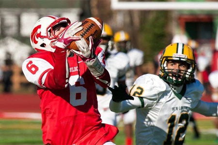 Norwich Free Academy's Nicholas Ramos
hauls in another pass from Erik Washburn.