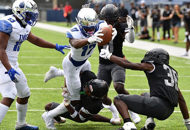 An IMG Academy player reaches for the end zone during his team's 58-0 thrashing of Bishop Sycamore in August.