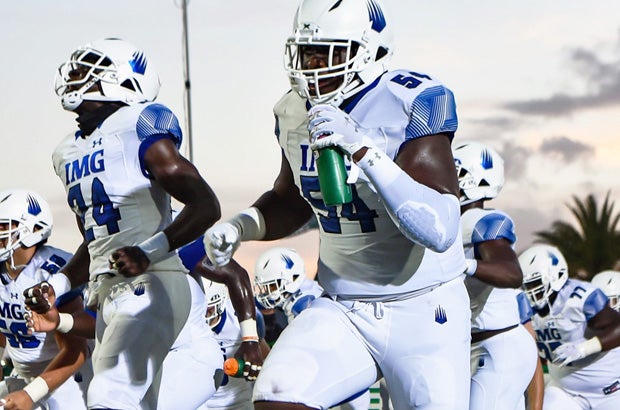 Kamari Wilson (24) and Tyler Booker (54) lead IMG onto the field during a 2020 game. Both are among 11 Ascenders on the Florida Top 50 player list for the Class of 2022. 