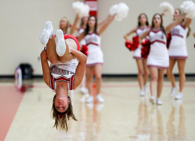 A Plainview (Okla.) cheerleader does a back flip during a boys basketball game against Kingston.