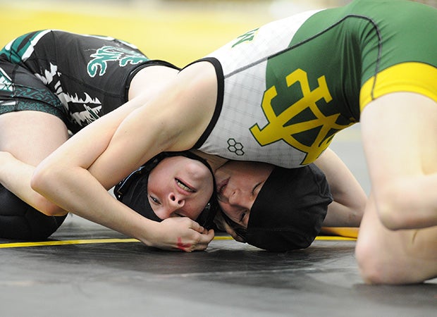 An Aliso Niguel (Calif.) wrestler (left) and a Mira Costa wrestler face off during a match in the Lady Big Kat Invitational.