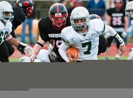 Quarterback Matt O'Keefe and 12-0 Duxbury (Mass.) have embraced a cause much larger than football, raising funds for the widow and daughter of a soldier.
