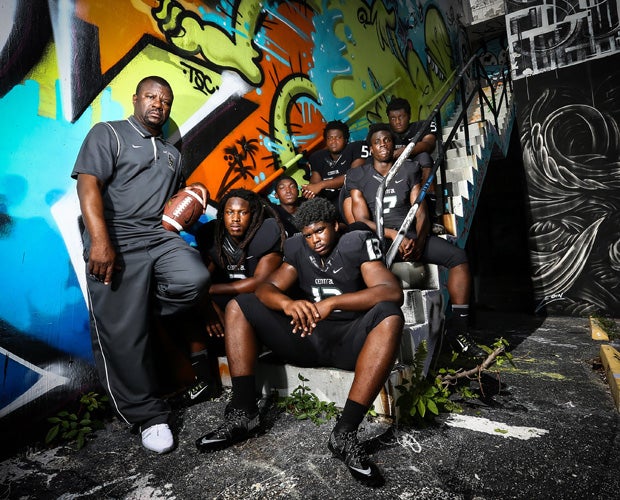 Central head coach Roland Smith poses along with six of his top players during a photo shoot at the Wynwood District in Miami.  