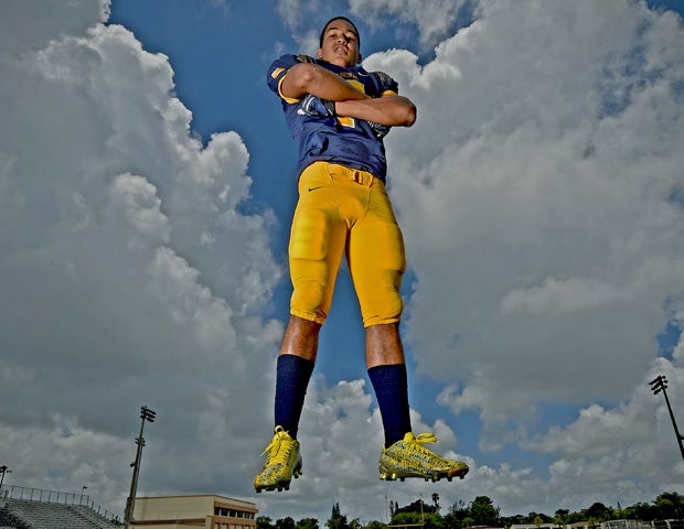 St. Thomas Aquinas' James Oliphant poses during a photo shoot at his school's football stadium. 