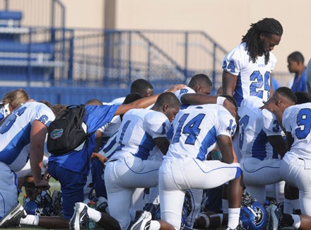 Matt Jones leads the Hawks in prayer before the game.