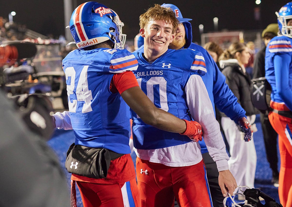 Folsom quarterback Brody Rudnicki and safety Daniel Eagleton celebrate the Bulldogs NorCal title against Archbishop Riordan last week. Tonight Rudnicki accounted for six touchdowns while Eagleton intercepted a pass as Folsom won the state title over Cathedral Catholic. (PHOTO: Anthony Brunsman)