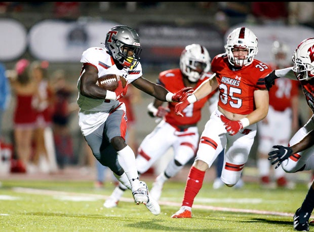 Thompson's Sam Reynolds avoids would-be Hewitt-Trussville tacklers in Friday's Alabama showdown. 