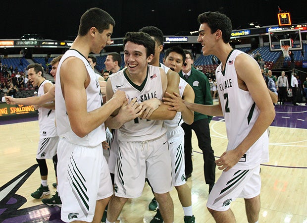 De La Salle's Colby Orr is mobbed by his teammates following the Spartans victory in the CIF NorCal Regional Open Division title game at Sleep Train Arena in Sacramento.