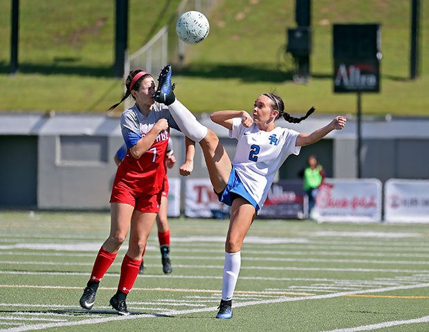 A Spring Hill (Texas) player narrowly misses taking a cleat to the face by a Midlothian Heritage player in a UIL 4A Regional II semifinal game.