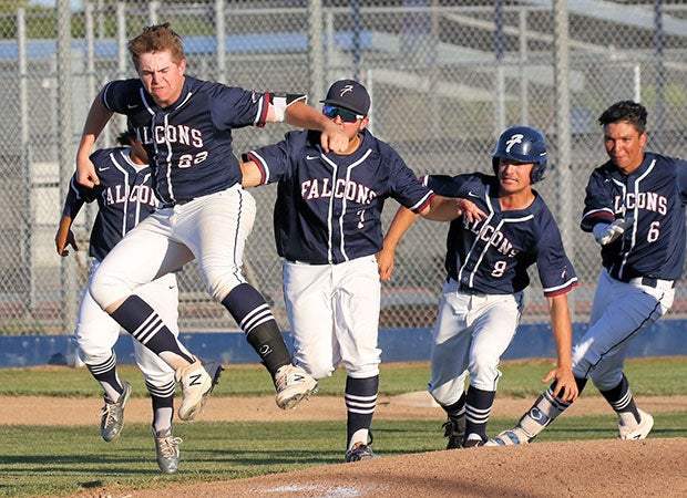 Colby Lane of Freedom (Calif.) leaps while celebrating his game-winning hit as his teammates chase after him following their victory over Heritage.