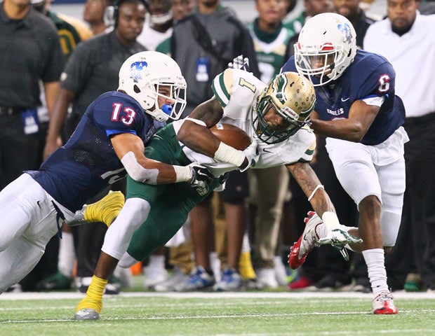 Allen linebacker Jakob Yandell (left) and defensive back Anthony Taylor (right) bring down DeSoto receiver Kevin Thomas.