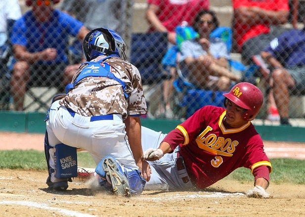 Jadon Uhrich of Rocky Mountain slides into home against Cherry Creek.